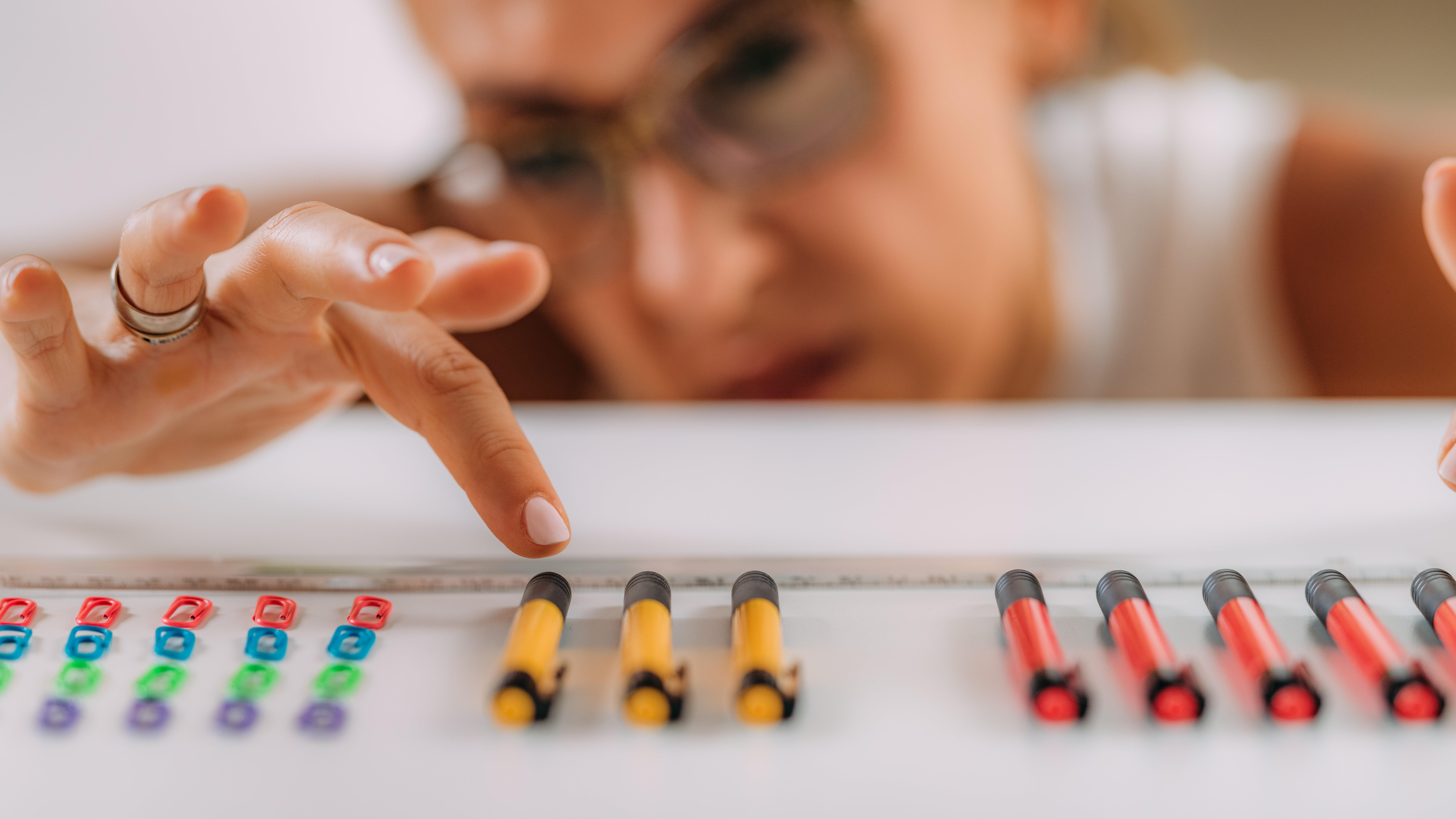 woman aligning pencils