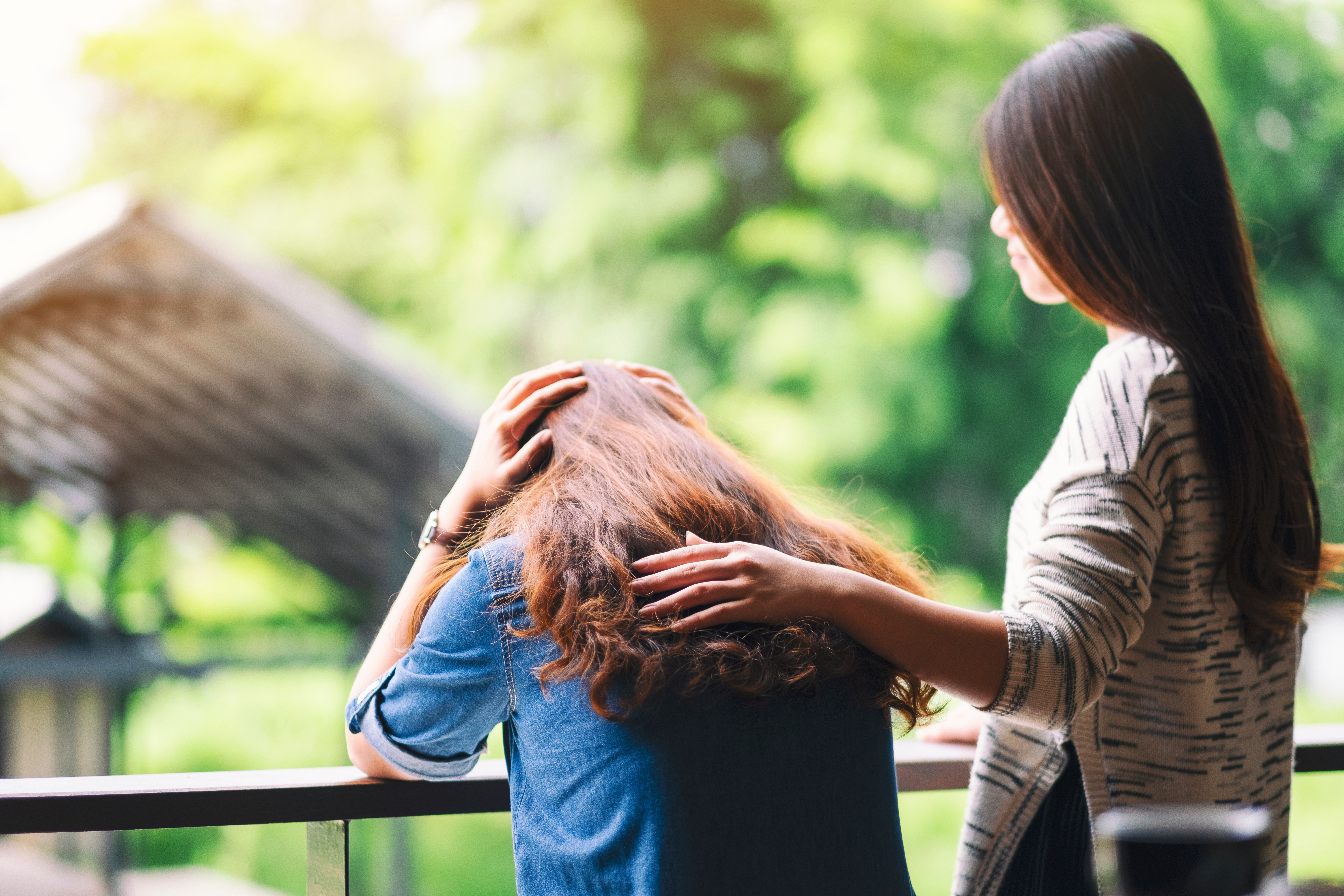 A woman comforting and giving encouragement to her sad friend