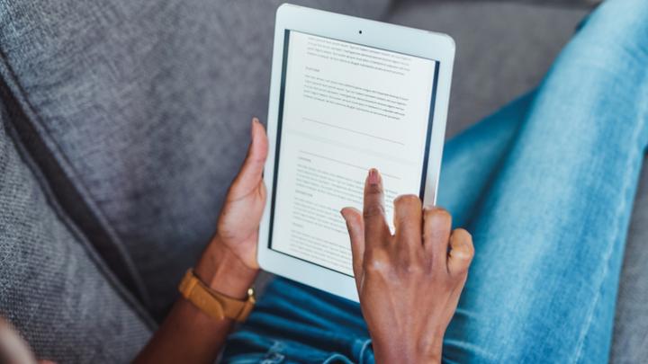 Shot of an unrecognisable woman using a digital tablet on the sofa at home