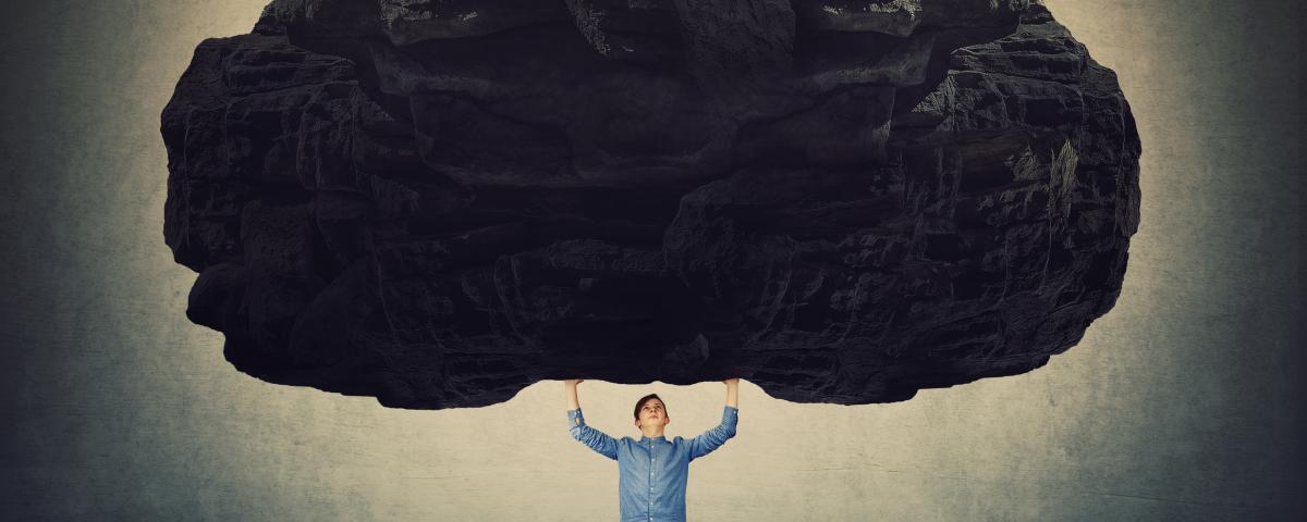 man carrying boulder